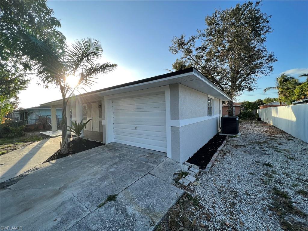 5345 Hardee Street Naples, FL 34113 - Photo 5 of 20 a view of a house with a yard and garage
