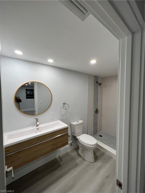 5345 Hardee Street Naples, FL 34113 - Photo 10 of 20 a bathroom with a sink a toilet and a mirror