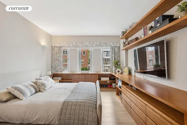 a bedroom with a large bed and a window