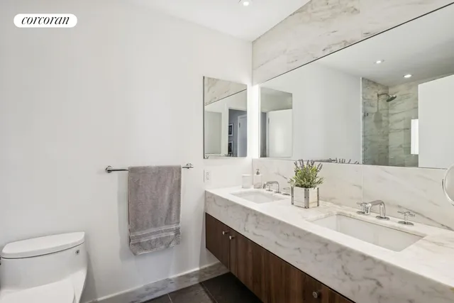 a large bedroom with a large bed and a large window with balcony view