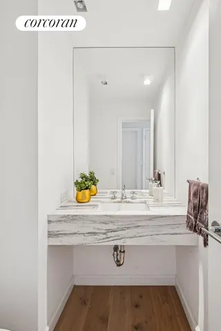 a bathroom with a granite countertop sink mirror and toilet