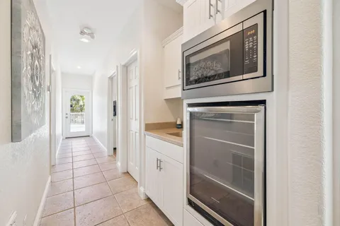 a hallway with cabinets and a painting on the wall