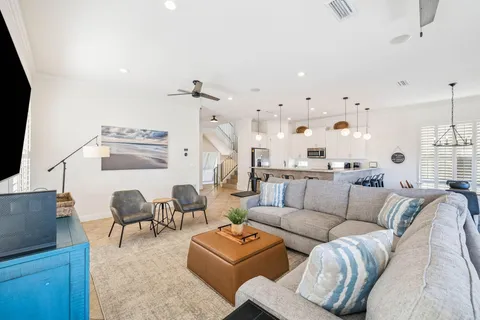 a living room with furniture and a chandelier