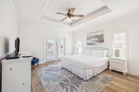 a bedroom with a large bed and a chandelier