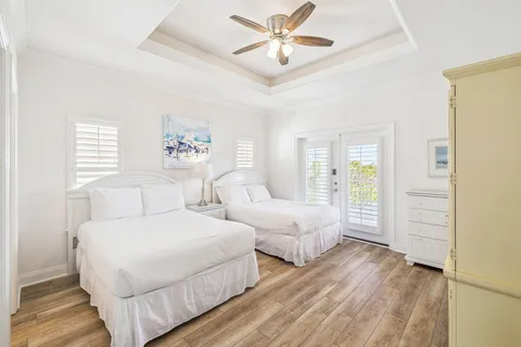a bedroom with two separate beds and a window