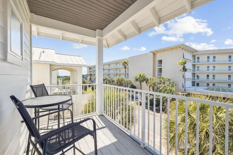 a view of a balcony dining area with furniture