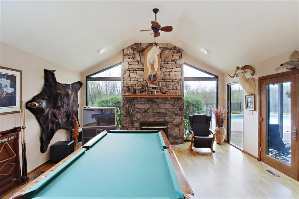 576 New Texas Road Pittsburgh, PA 15239 - Photo 15 of 25 Huge stone wood-burning fireplace with custom-designed oversized windows help you enjoy the view into your quiet & private back yard.