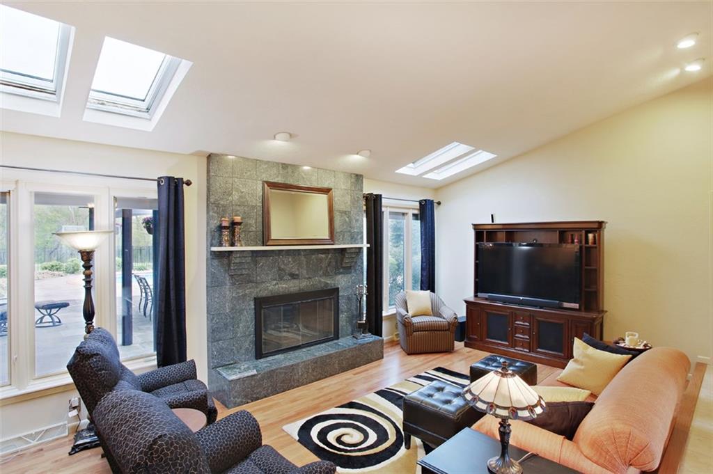 576 New Texas Road Pittsburgh, PA 15239 - Photo 8 of 25 Sunken living room appointed with marble fireplace, large casement windows, recessed lights & skylights above.