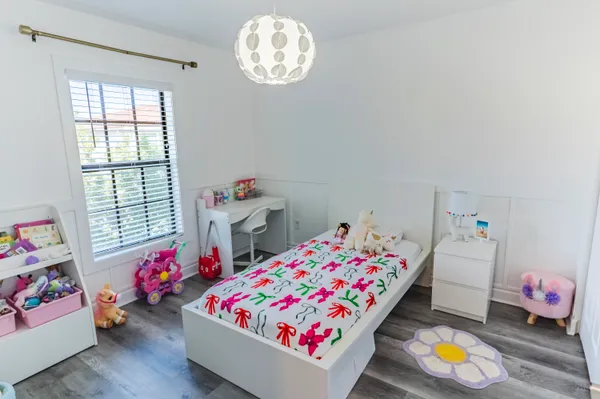 a bedroom with toys and a window