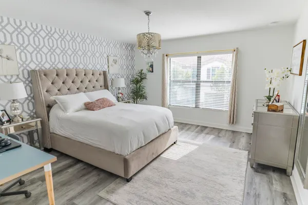 a bedroom with a large bed and a window