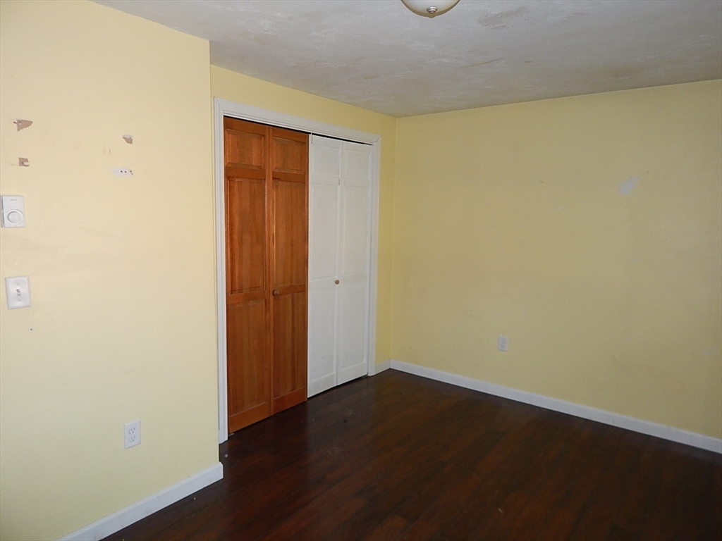 1865 Barre Road Hardwick, MA 01031 - Photo 9 of 15 an empty room with wooden floor and closet