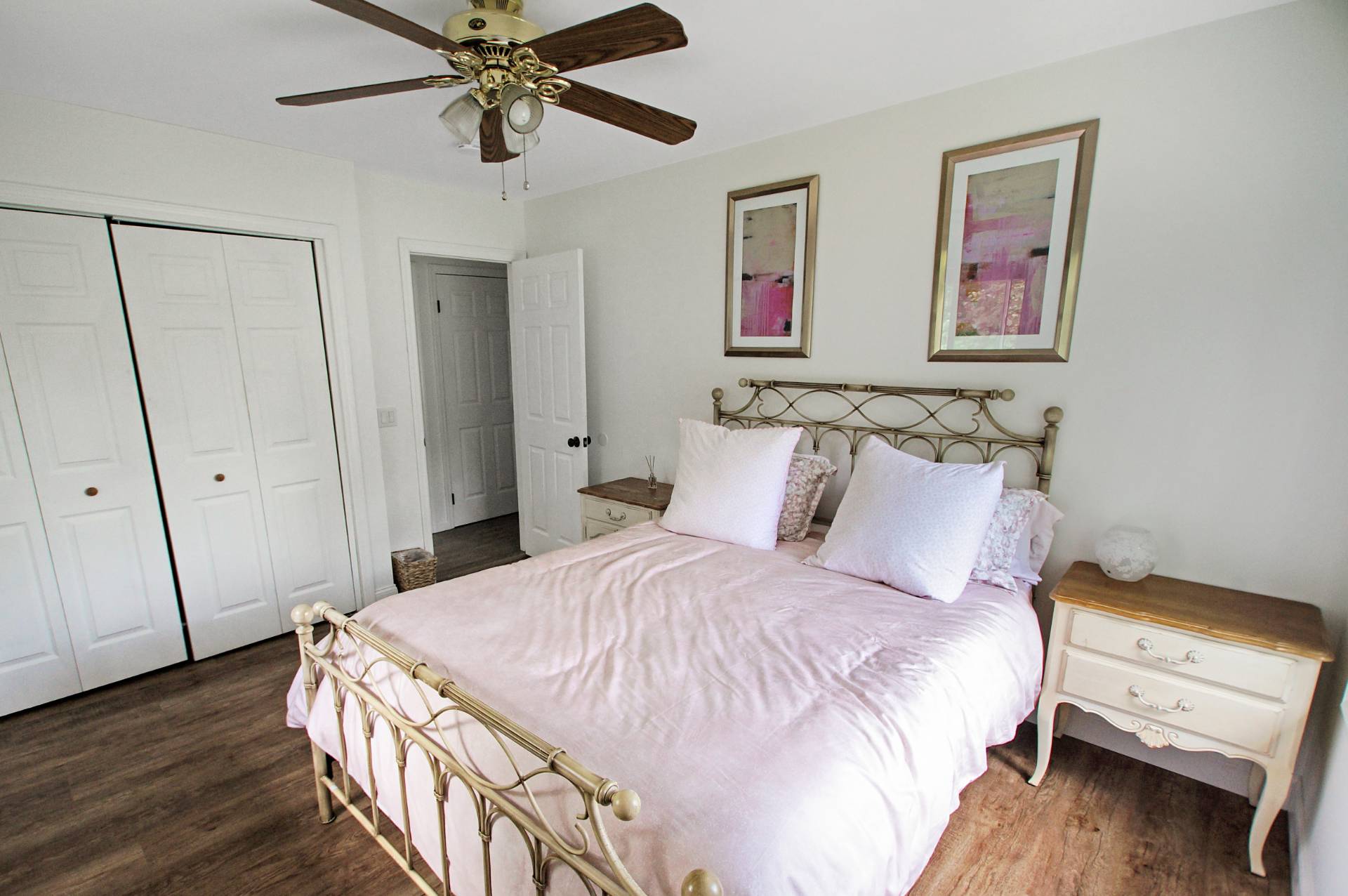 16 Norbury Road Hampton Bays, NY 11946 - Photo 15 of 32 a bedroom with a bed and a chandelier