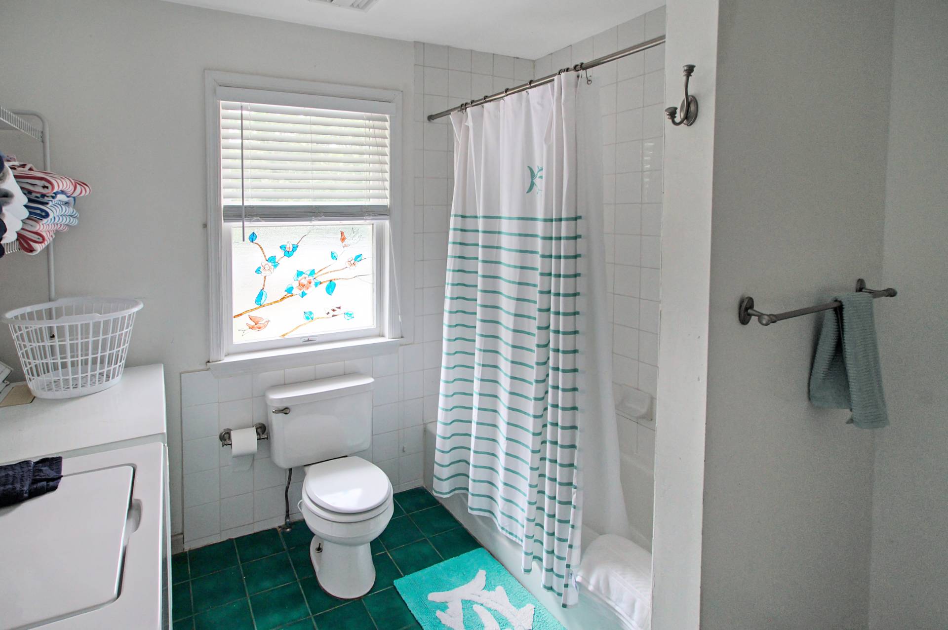 16 Norbury Road Hampton Bays, NY 11946 - Photo 17 of 32 a bathroom with a toilet and a shower curtain