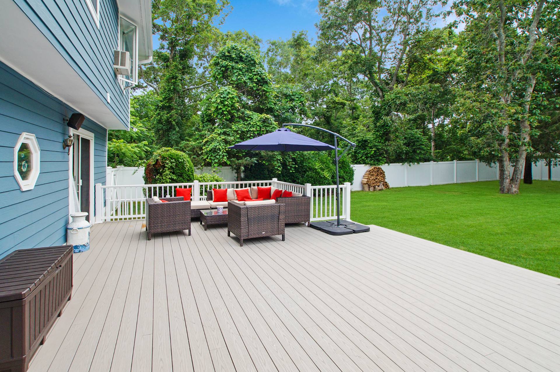 16 Norbury Road Hampton Bays, NY 11946 - Photo 18 of 32 a view of a patio with a table and chairs under an umbrella with wooden floor