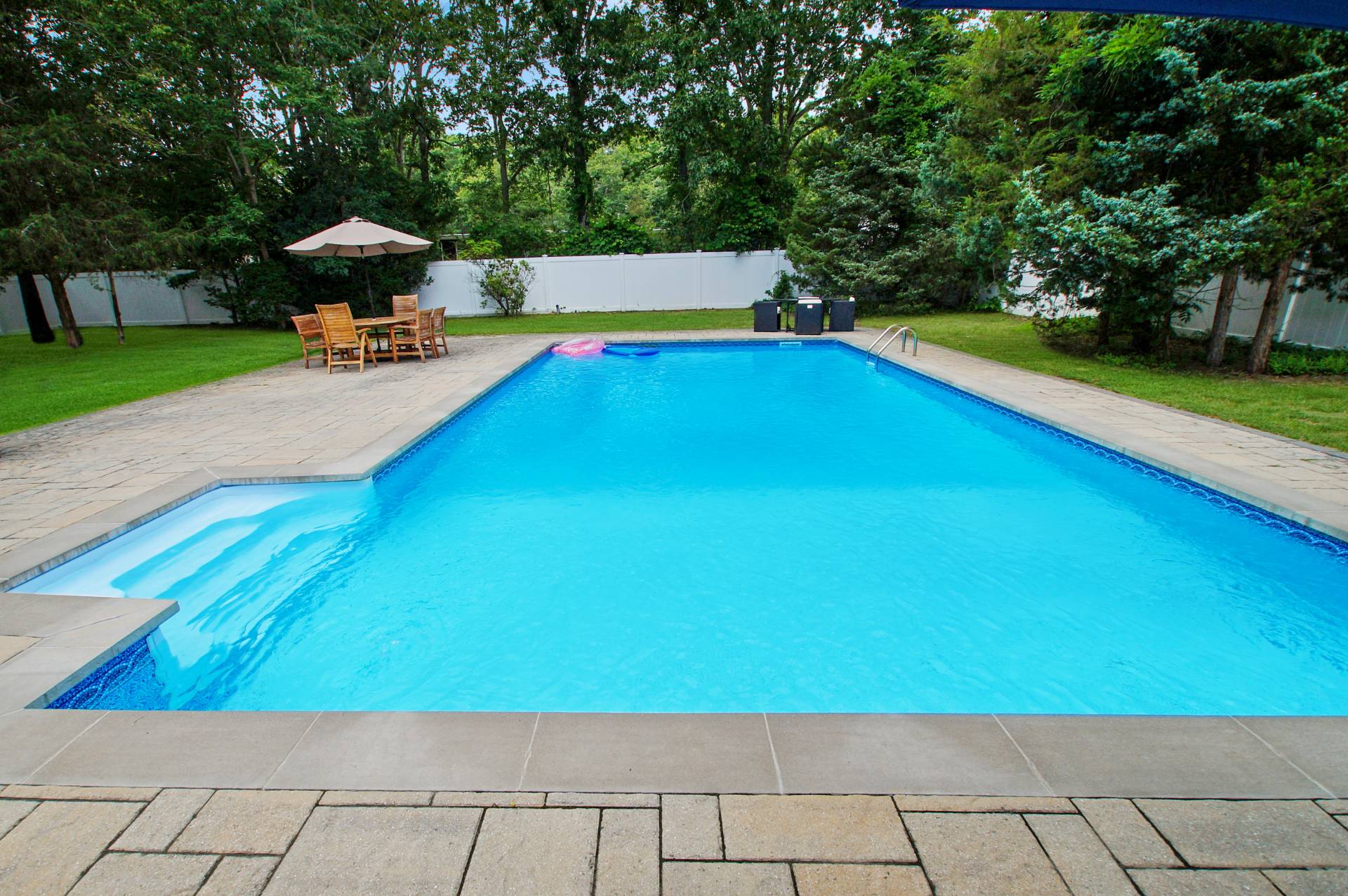 16 Norbury Road Hampton Bays, NY 11946 - Photo 20 of 32 a view of a swimming pool with an outdoor seating and a yard