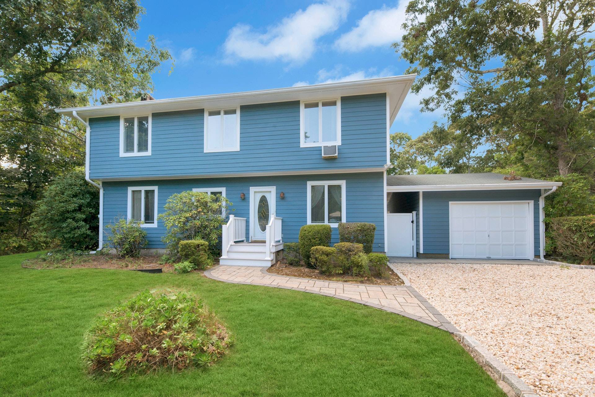 16 Norbury Road Hampton Bays, NY 11946 - Photo 2 of 32 a front view of a house with a yard and porch