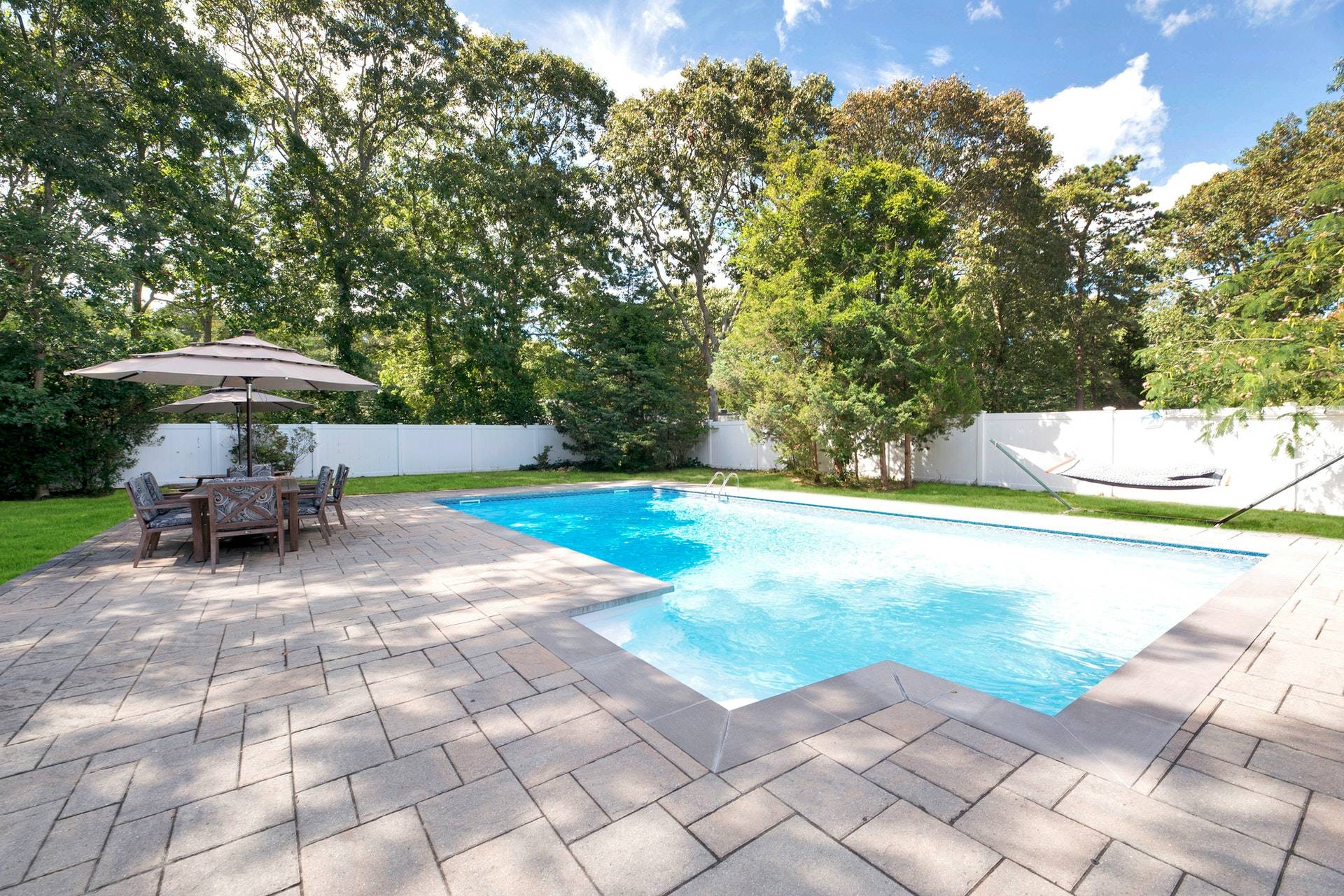 16 Norbury Road Hampton Bays, NY 11946 - Photo 23 of 32 a view of backyard with swimming pool and furniture