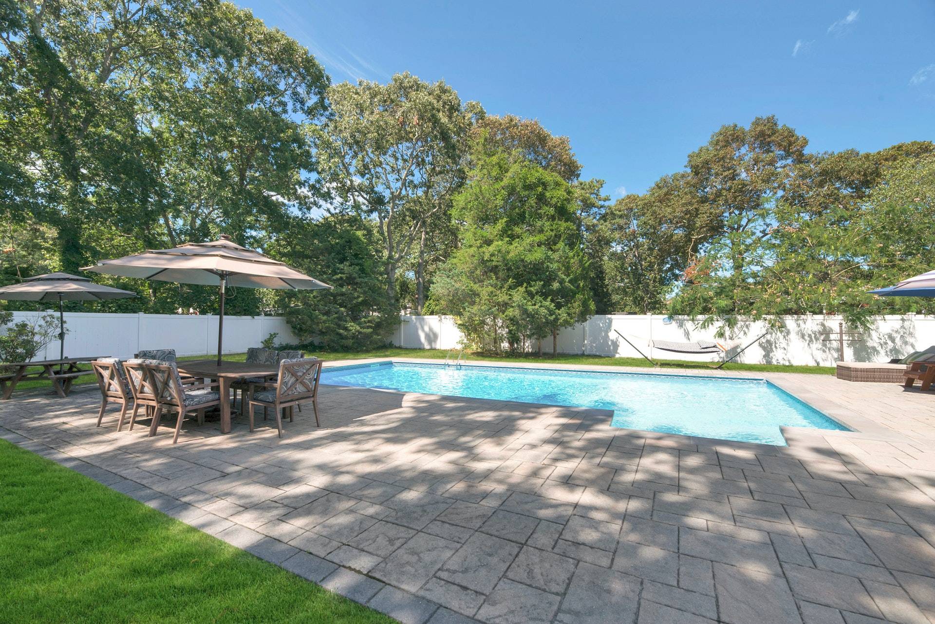 16 Norbury Road Hampton Bays, NY 11946 - Photo 28 of 32 a view of a swimming pool with a patio
