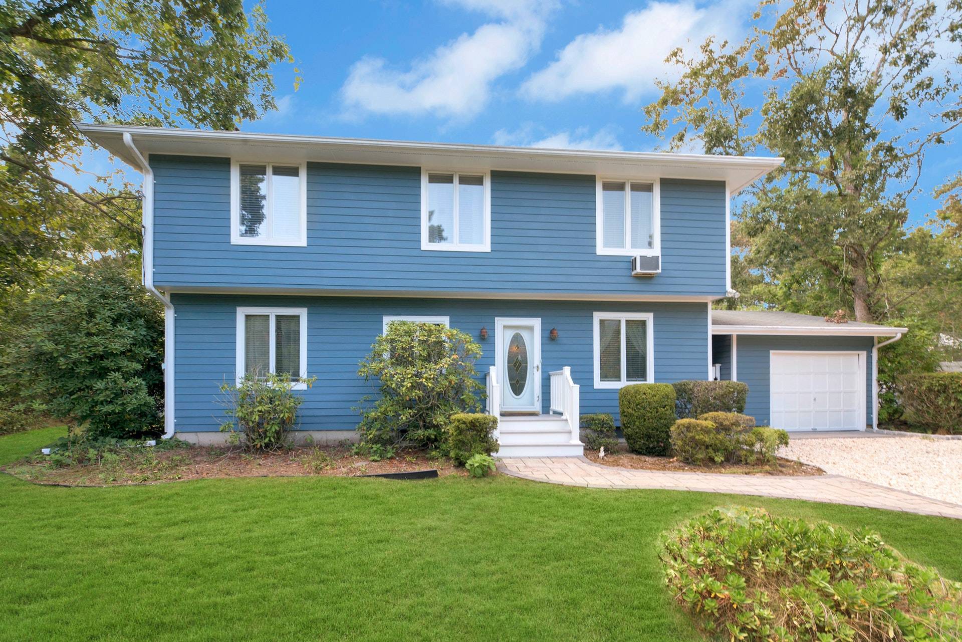 16 Norbury Road Hampton Bays, NY 11946 - Photo 32 of 32 a front view of a house with a yard and garage