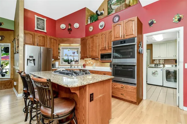 a bathroom with a granite countertop sink and a large mirror