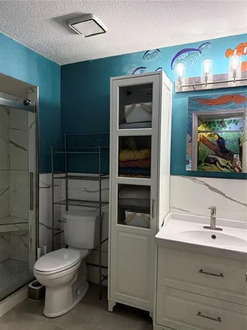 an aerial view of a house with a yard and lake view