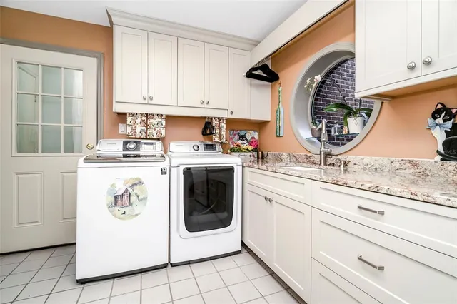 a view of a big house with a big yard and large trees