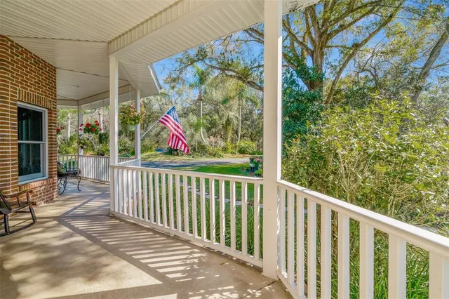 a living room with furniture a rug and a painting on the wall