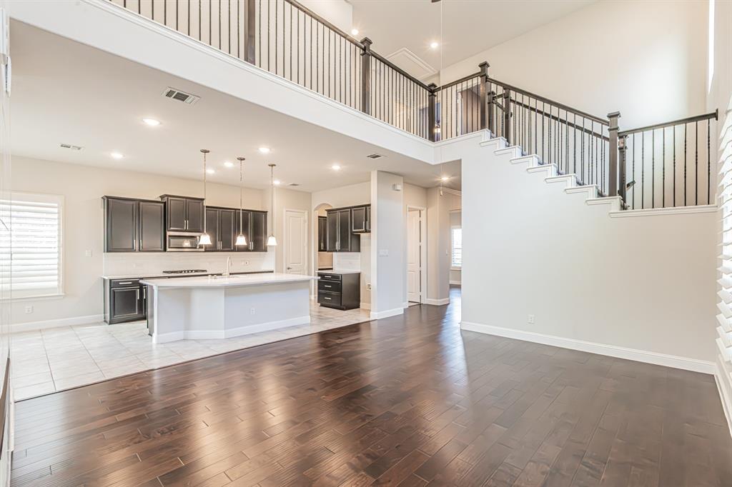 304 Adam Way Euless, TX 76040 - Photo 11 of 39 Unfurnished living room featuring light wood-type flooring, recessed lighting, and a high ceiling