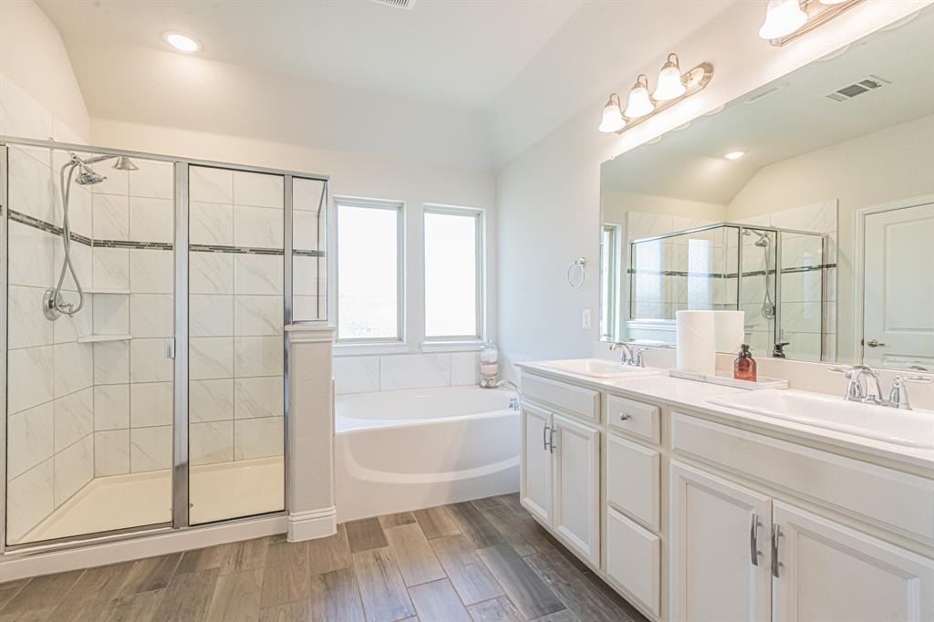 304 Adam Way Euless, TX 76040 - Photo 21 of 39 Full bathroom featuring double vanity, a bath, wood finish floors, a stall shower, and recessed lighting