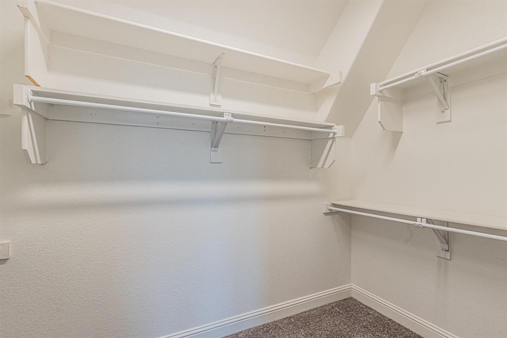 304 Adam Way Euless, TX 76040 - Photo 23 of 39 Walk in closet with dark colored carpet