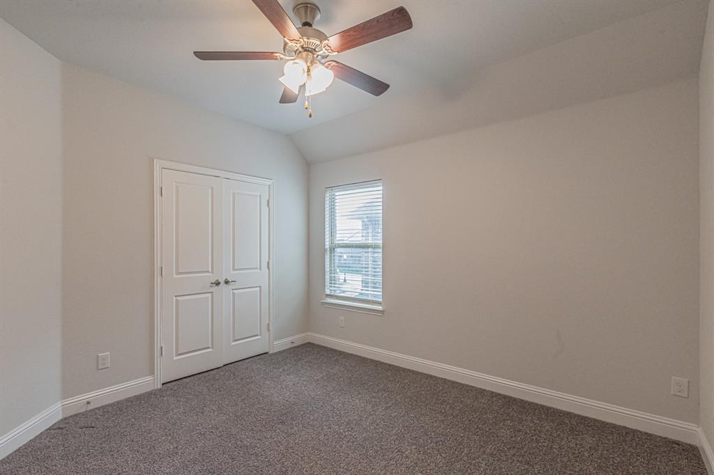 304 Adam Way Euless, TX 76040 - Photo 26 of 39 Unfurnished bedroom with dark colored carpet, lofted ceiling, ceiling fan, and a closet