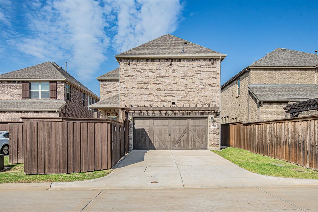 304 Adam Way Euless, TX 76040 - Photo 34 of 39 View of front of house with a shingled roof, brick siding, a garage, and concrete driveway
