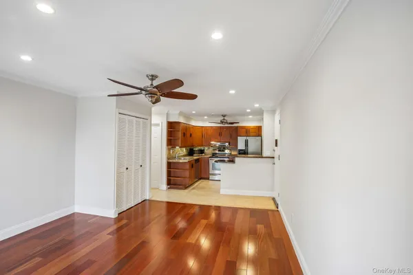 a view of workspace with wooden floor and chandelier
