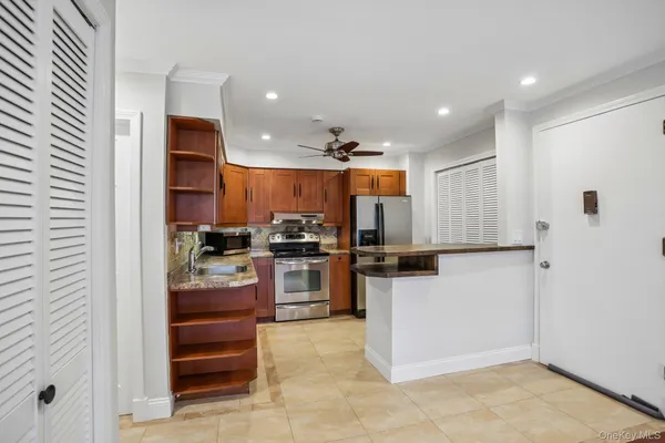 a kitchen with a refrigerator and a stove top oven