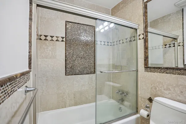 a bathroom with a shower and a toilet