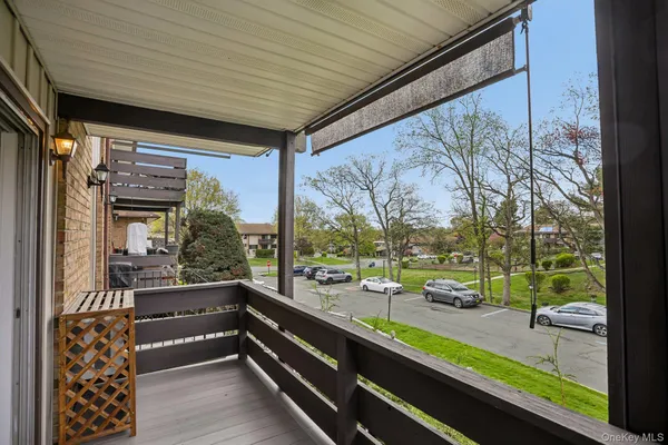 a view of balcony with wooden floor and bench