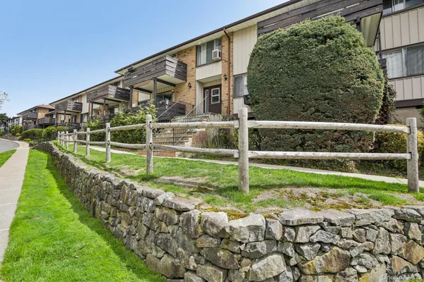 a view of a house in front of a big yard