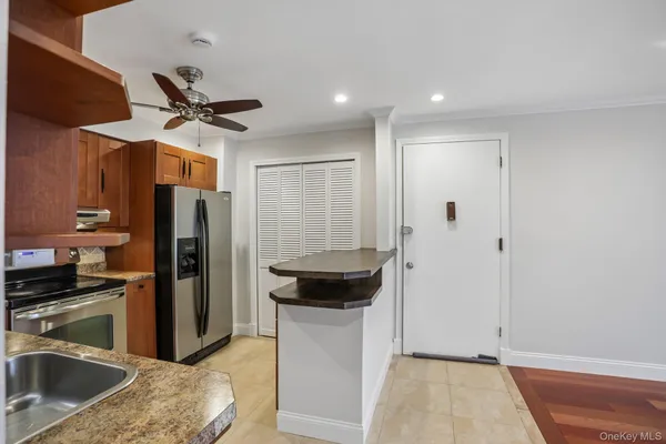 a kitchen with a refrigerator and a sink