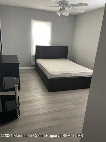 a bedroom with a bed and a mirror