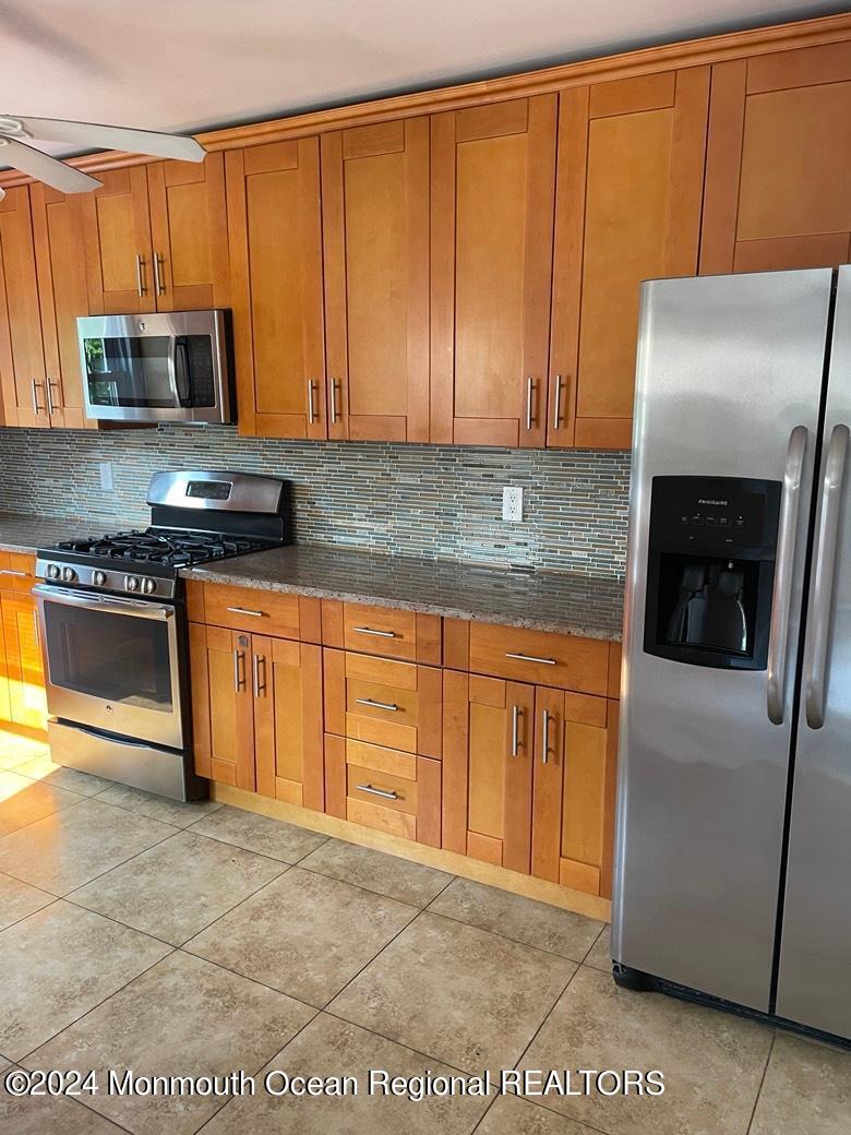 3 Berger Avenue Oakhurst, NJ 07755 - Photo 3 of 12 a kitchen with stainless steel appliances granite countertop a refrigerator a stove a sink and dishwasher