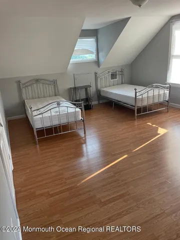 a room with wooden floor and furniture