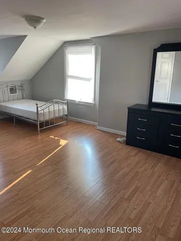 a bed room with a bed and a window