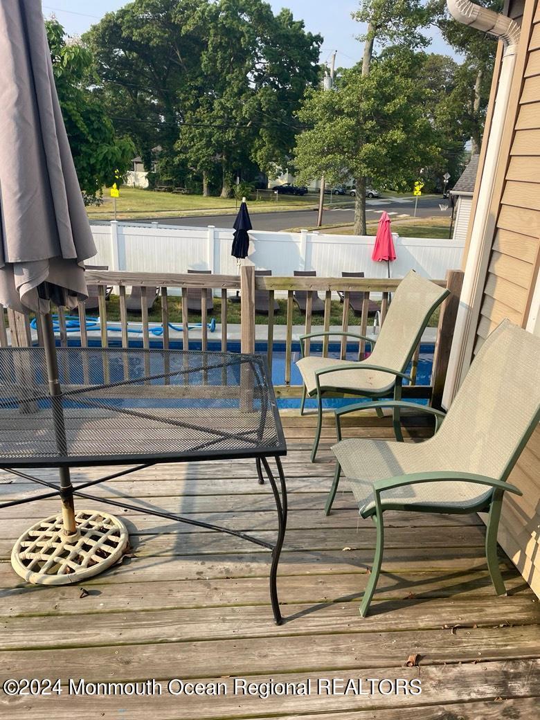 3 Berger Avenue Oakhurst, NJ 07755 - Photo 8 of 12 a view of a swimming pool with seating area