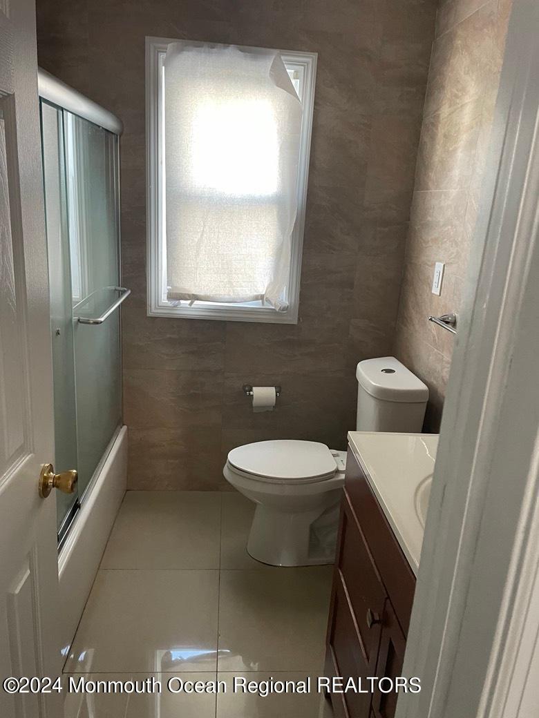 3 Berger Avenue Oakhurst, NJ 07755 - Photo 10 of 12 a bathroom with a toilet a sink and mirror