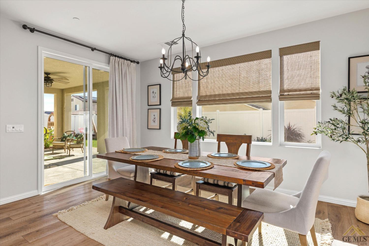 Undisclosed Address Bakersfield, CA 93311 - Photo 14 of 37 a dining room with furniture a chandelier and wooden floor