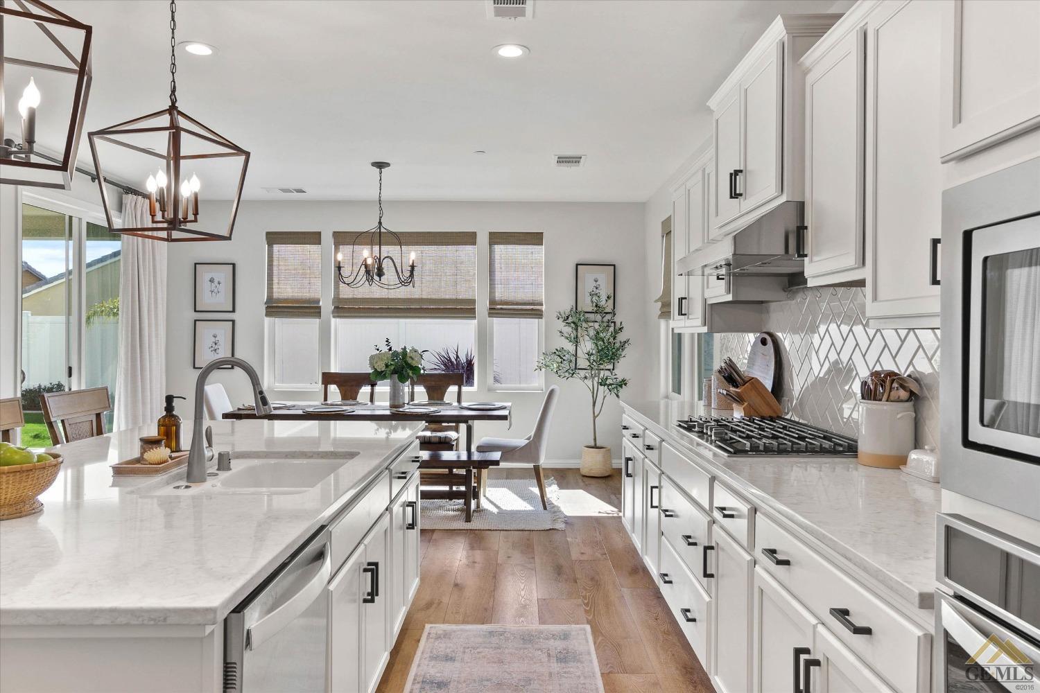Undisclosed Address Bakersfield, CA 93311 - Photo 18 of 37 a kitchen with stainless steel appliances granite countertop a sink stove and cabinets