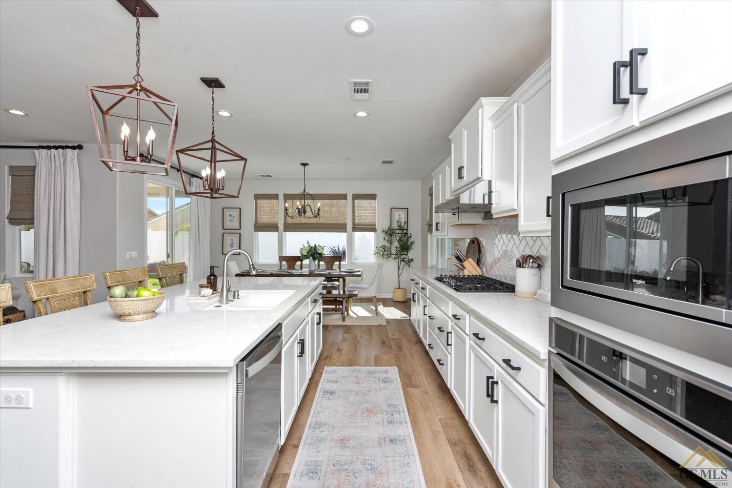 Undisclosed Address Bakersfield, CA 93311 - Photo 19 of 37 a kitchen with a sink stove and cabinets