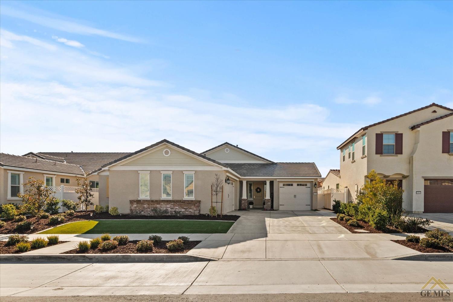 Undisclosed Address Bakersfield, CA 93311 - Photo 2 of 37 a front view of a house with yard and parking