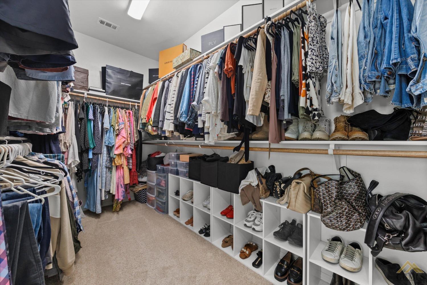 Undisclosed Address Bakersfield, CA 93311 - Photo 23 of 37 a view of walk in closet with clothes and shoes