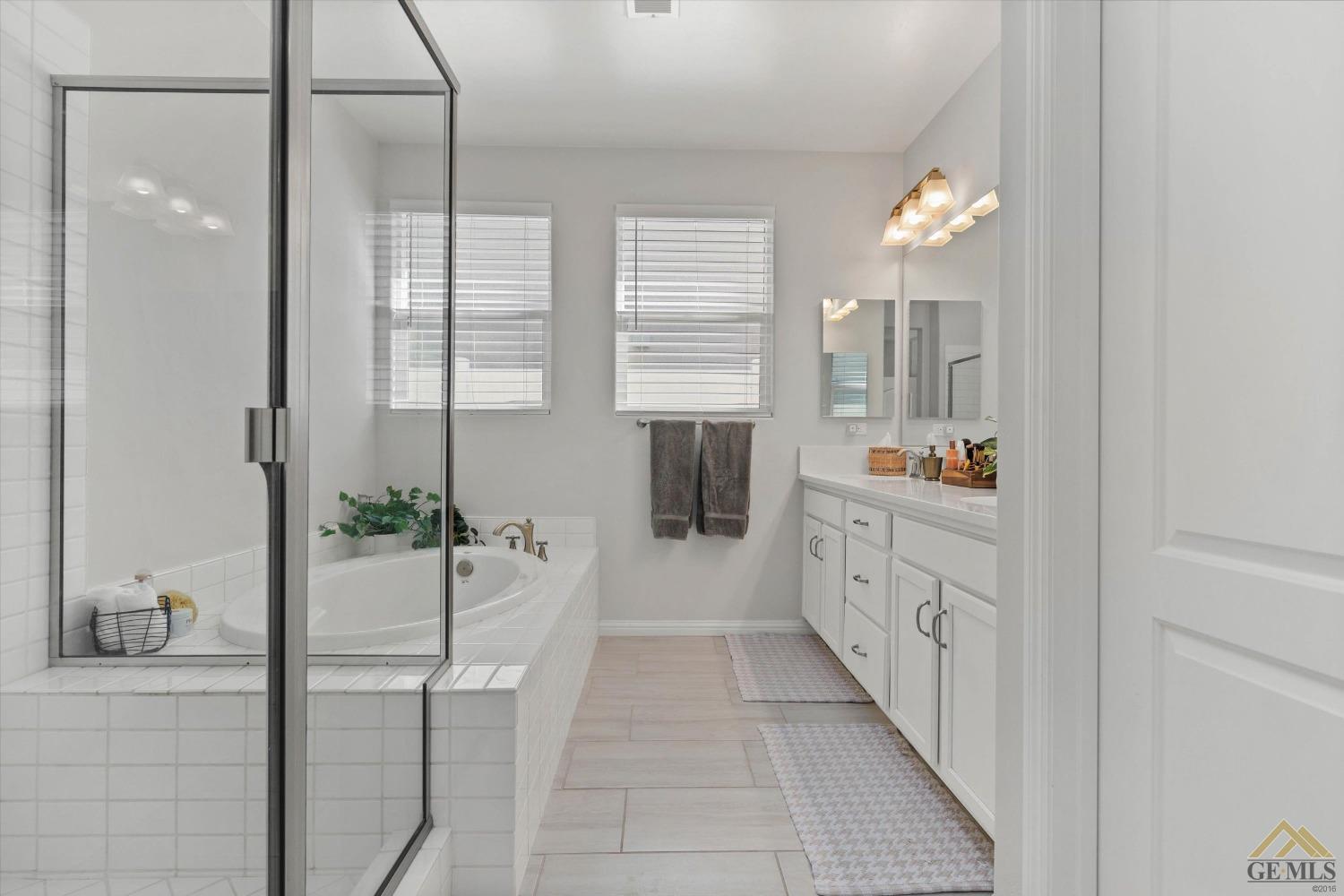 Undisclosed Address Bakersfield, CA 93311 - Photo 24 of 37 a bathroom with a tub sink and mirror